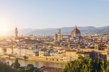 Fototapeta premium Florence cityscape with Duomo, Palazzo Vecchio, and Arno river at sunset, panorama of historic Italian architecture