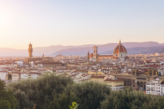 Florence cityscape at sunrise with Duomo and Bargello tower dominating the historic skyline over Tuscan hills