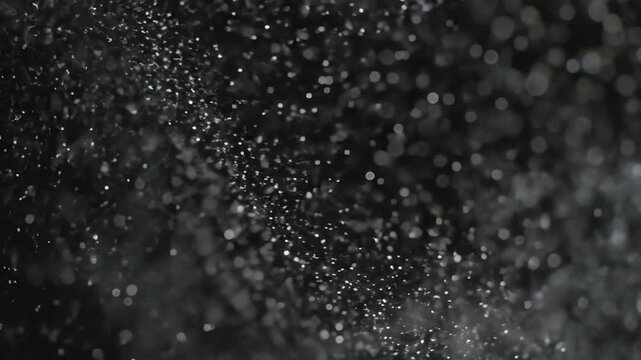 Abstract scattering of white particles against a dark background, dynamic motion