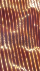 Shimmering golden light trails falling in vertical streams, creating a warm, glowing abstract motion effect © Bolbik