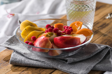 Healthy Fruit Plate with banana, apples, oranges anf glass of water.