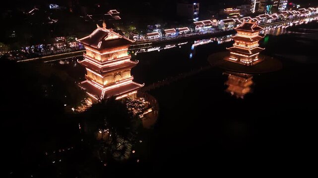 Ancient pagodas in hoa lu at night reflecting on the river, ninh binh, vietnam aerial view