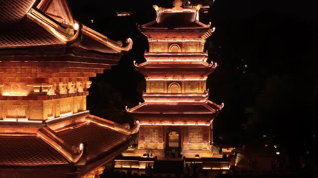 Ancient pagodas in hoa lu at night reflecting on the river, ninh binh, vietnam aerial view