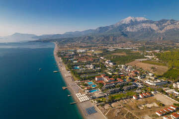 Aerial drone view of Mediterranean coastline with beach resorts and Taurus Mountains in Kemer Turkey