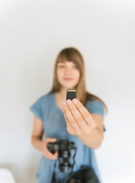 Woman's hand holding memory card, close-up