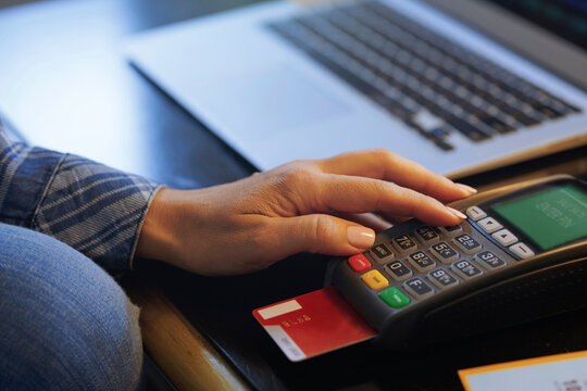 Woman with laptop using online banking, close-up