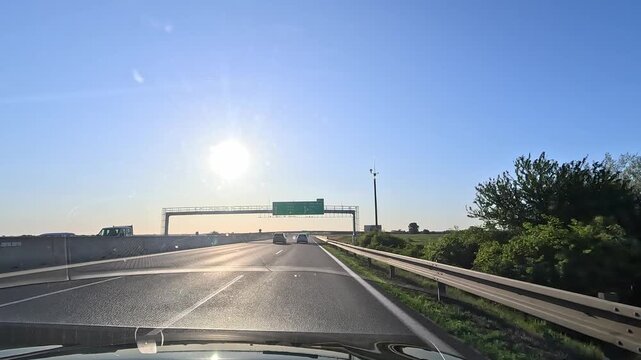 Driving on D1 highway in western Slovakia with low sun glare during sunny evening