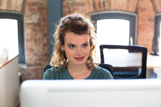 Young woman working at desk in modern office