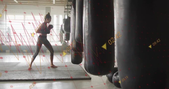Female boxer stepping forward and striking heavy bags for training in gym, timing overlays sweeping