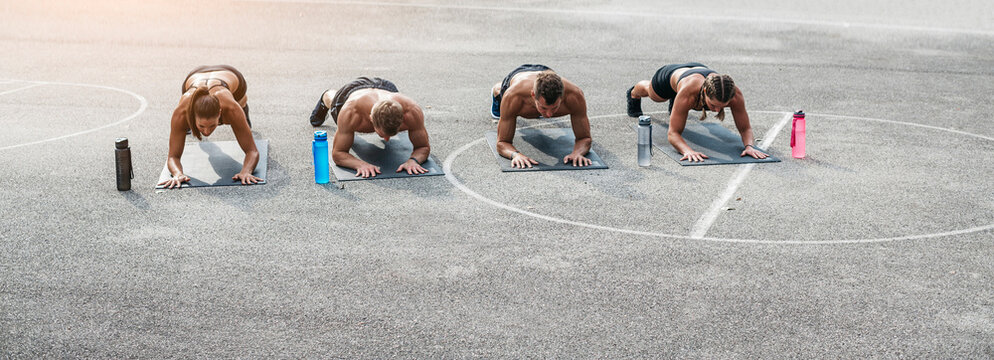 Sporty team during workout, plank