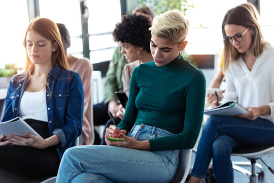 Businesswomen writing during a training