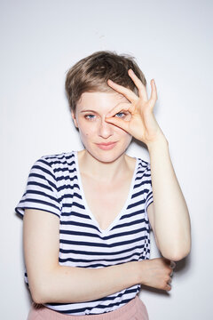 Portrait of blond woman, short hair, forming glasses