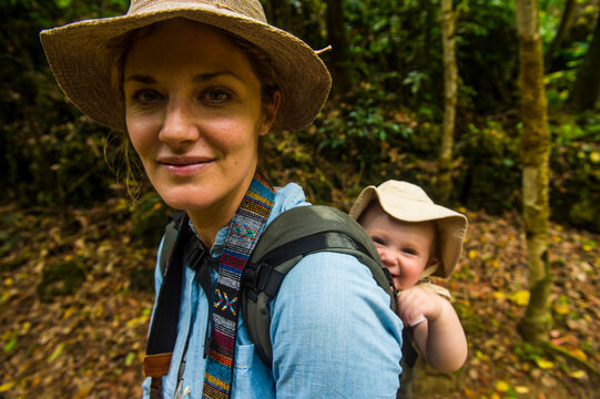 Japan, Okinawa, Woman hiking with her baby through the Unesco world heritage sight, sacred site Sefa Utaki