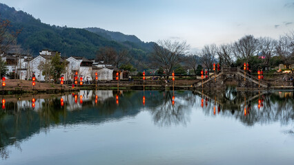 Fototapeta premium Traditional Chinese Village by Lake with Lanterns