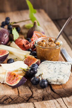 Cheese platter with fruits and fig mustard