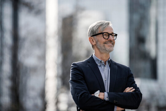 Smiling grey-haired businessman outdoors