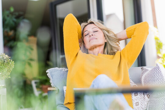 Portrait of mature woman with eyes closed relaxing on terrace