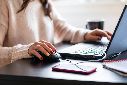 Woman using laptop and mouse