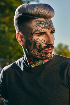 Portrait of tattooed young man outdoors