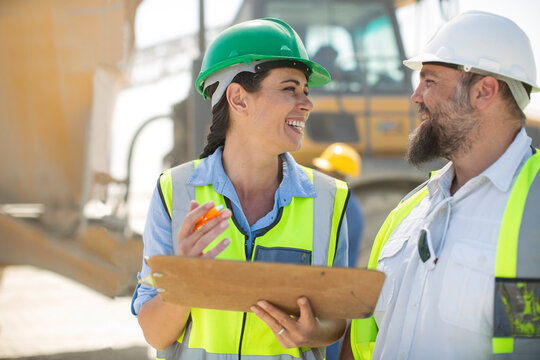 Male and female quarry workers discussing on site
