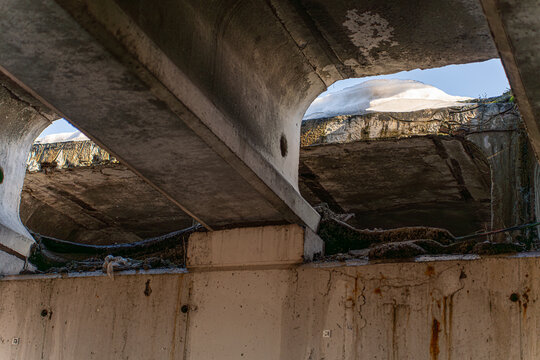 Irpin, Ukraine - 07 March 2026: View of the Irpin Bridge, a concrete skeleton against a pale sky, bearing the scars of conflict and remnants of snow.