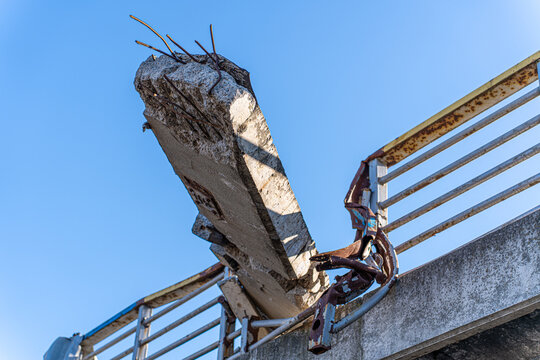 Irpin, Ukraine - 07 March 2026: View of the bridge's mangled concrete and twisted metal against a clear blue sky, a stark reminder of conflict's destructive force.