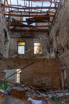 Irpin, Ukraine - 07 March 2026: View of a ravaged interior at 31 Universitetska Street, where fractured brick walls meet the sky through a skeletal roof.