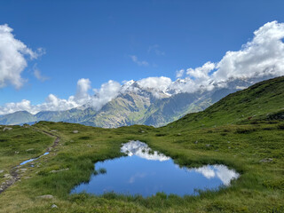 Small alpine pond reflecting Mont Blanc peaks, France