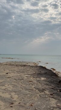 A calm beachside view of Sila near the Abu Dhabi&ndash;Saudi border shows quiet shores, soft waves, and open desert coastline.