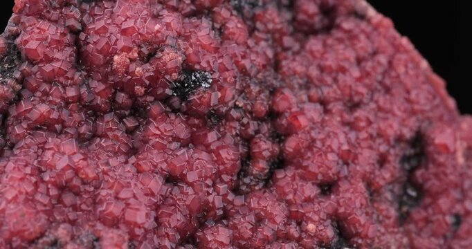 Andradite garnet on Manganite footage. Specimen from N'Chwaning II, South Africa. macro footage detail texture background. close-up mineral crystal unpolished semi-precious gemstone