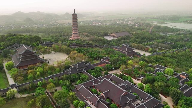 Aerial view of bai dinh pagoda complex with ancient temples and lush green gardens in ninh binh, vietnam