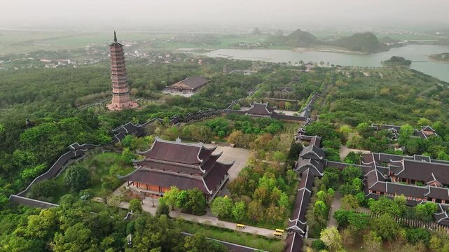Aerial view of bai dinh pagoda complex with its towering stupa, traditional temples, and lush gardens in ninh binh, vietnam
