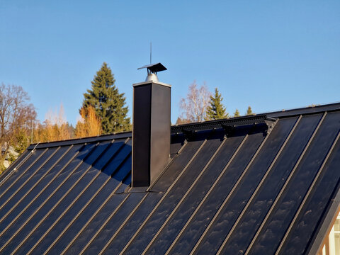  roof in anthracite color, shade RAL 7016. This type of roofing is very popular for its high durability, modern minimalist appearance, long service life, folded sheet metal, often aluminum or steel, w