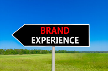 Brand experience symbol. Concept words Brand experience on beautiful black road sign. Beautiful blue sky green grass field background. Business branding and brand experience concept. Copy space.