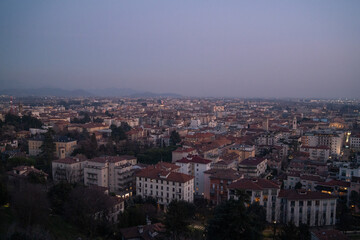 Obraz premium Golden sunset over Bergamo city with dramatic sky and historic skyline in Lombardy Italy.