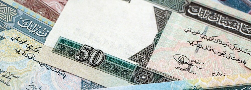 Afghan afghani paper banknotes pile on table. Afghanistan AFN currency money bills in big amount. Concept of economics, taxation and banking in Afghanistan