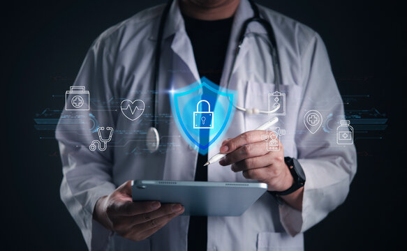 Male doctor using tablet and stylus with glowing virtual shield and padlock hologram. Concept of healthcare cybersecurity, medical data protection, patient privacy, and secure health records.