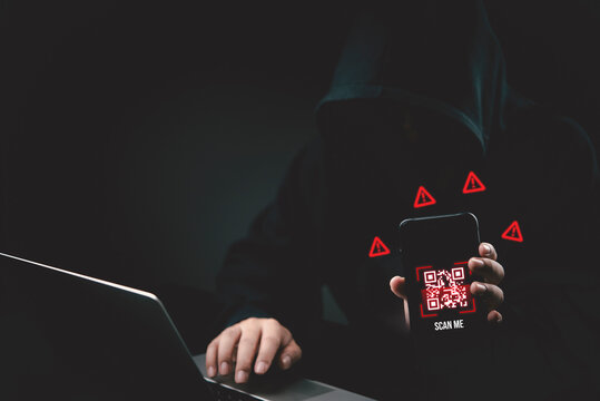 Anonymous hacker holding smartphone with malicious QR code scam and warning signs. Cyber security, phishing, data breach, malware, mobile threat, identity theft, internet fraud crime concept.