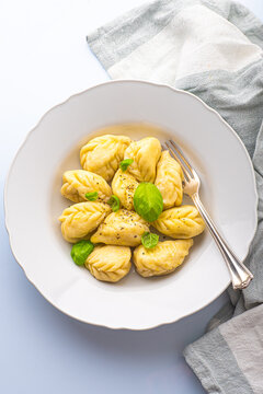 Culurgiones, typical ravioli of Sardinia. A first course of Sardinia: culurgiones or culugiornis, typical stuffed ravioli closed in an ear of wheat, best Sardinian culinary, pasta 