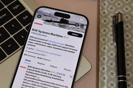 Kiel, Germany - 03-10-2026: X (Twitter) Profile of British defence company BAE Systems Maritime displayed on smartphone lying on a laptop keyboard