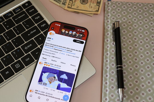 Kiel, Germany - 03-10-2026: X (Twitter) Profile of German public broadcaster ZDF displayed on smartphone lying on a laptop keyboard