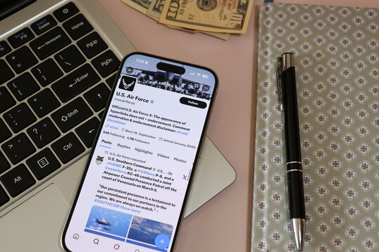 Kiel, Germany - 03-10-2026: X (Twitter) Profile of US air force U.S. Air Force displayed on smartphone lying on a laptop keyboard