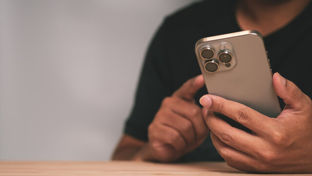 Close up of a man using smartphone for mobile banking and secure online payment. Concept of cyber security, data privacy protection, fintech innovation and modern digital finance technology.