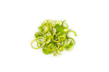 Fresh lime zest isolated on white background. Lime zest or peel close-up. Grated citrus peel. Lime...