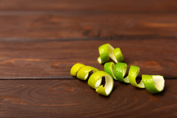 Fresh lime zest isolated on white background. Lime zest or peel close-up. Grated citrus peel. Lime...