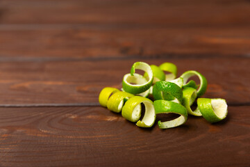 Fresh lime zest isolated on white background. Lime zest or peel close-up. Grated citrus peel. Lime...