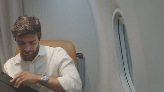 The concept relates to travel and business airline. A businessman falls asleep in first class on an airplane. Passengers are preparing to disembark after landing. airplane landing on runway.