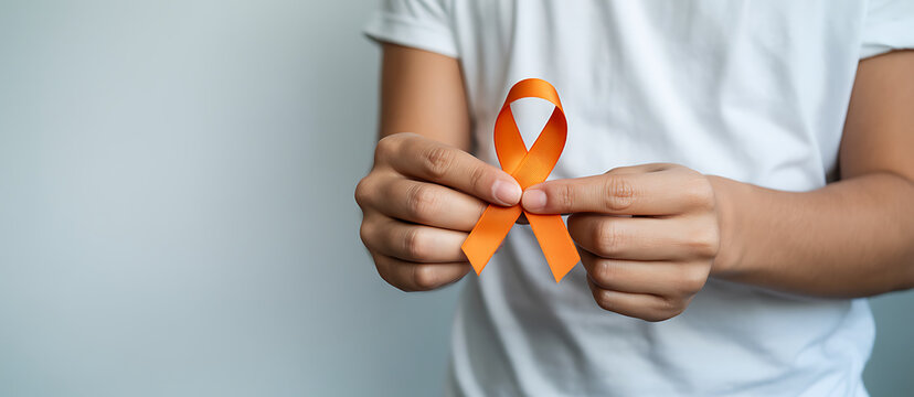 woman with Orange Ribbon for Leukemia, Kidney cancer day, world Multiple Sclerosis, CRPS, Self Injury Awareness month. Healthcare and word cancer day concept