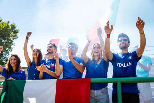 Italian sports fans cheering national team in stadium