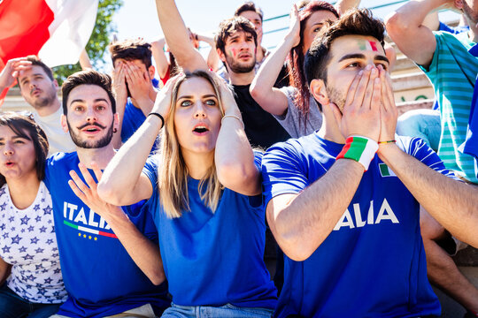 Italian football fans reacting with shock and disappointment